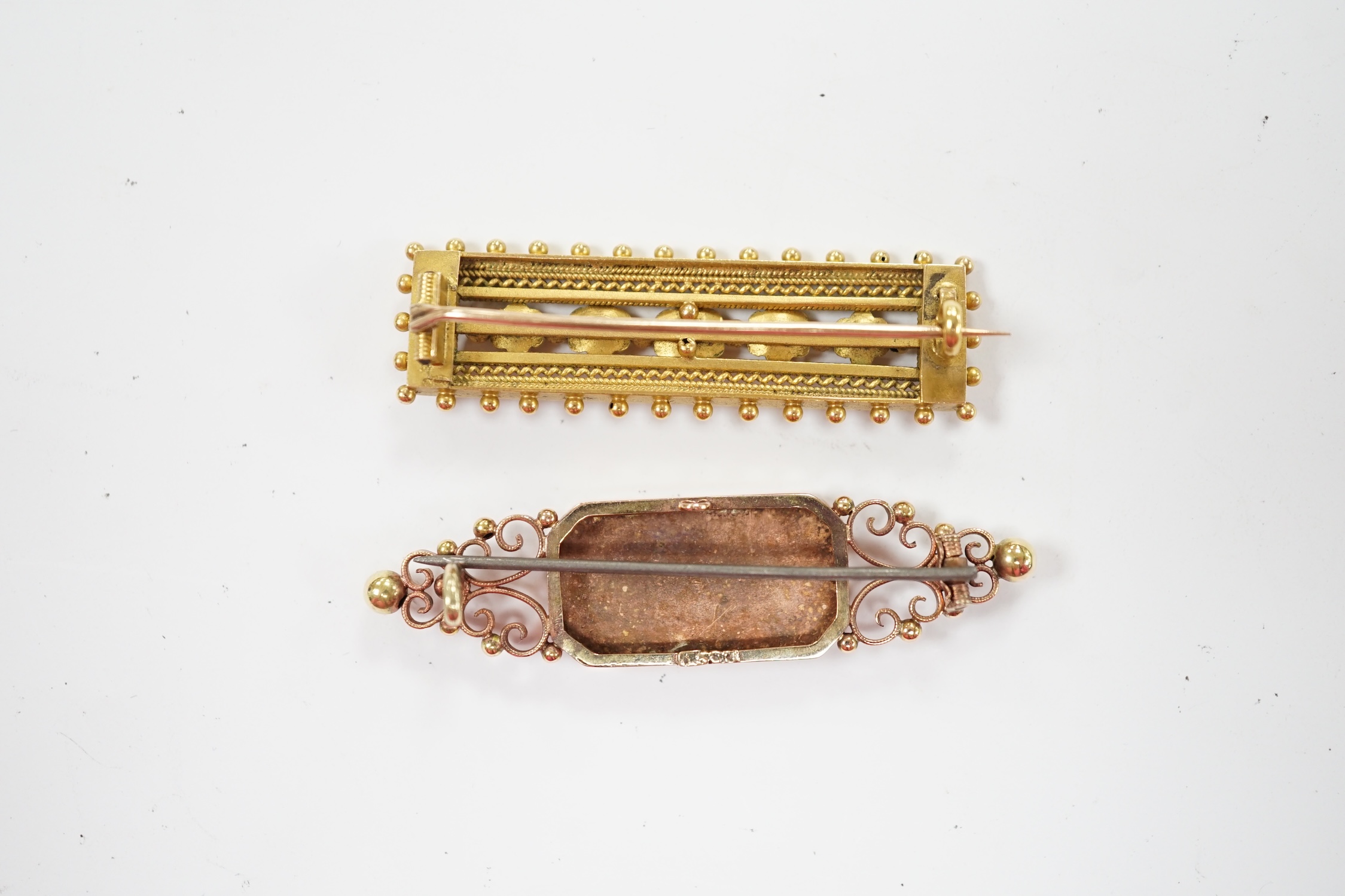 A late Victorian yellow metal cannetille work brooch, 45mm, 6.4 grams, together with a 15ct brooch, with later inscription, gross 6.2 grams. Fair condition.